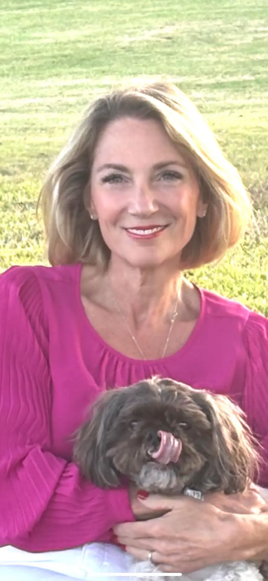 Michelle Barker holding her dog outdoors